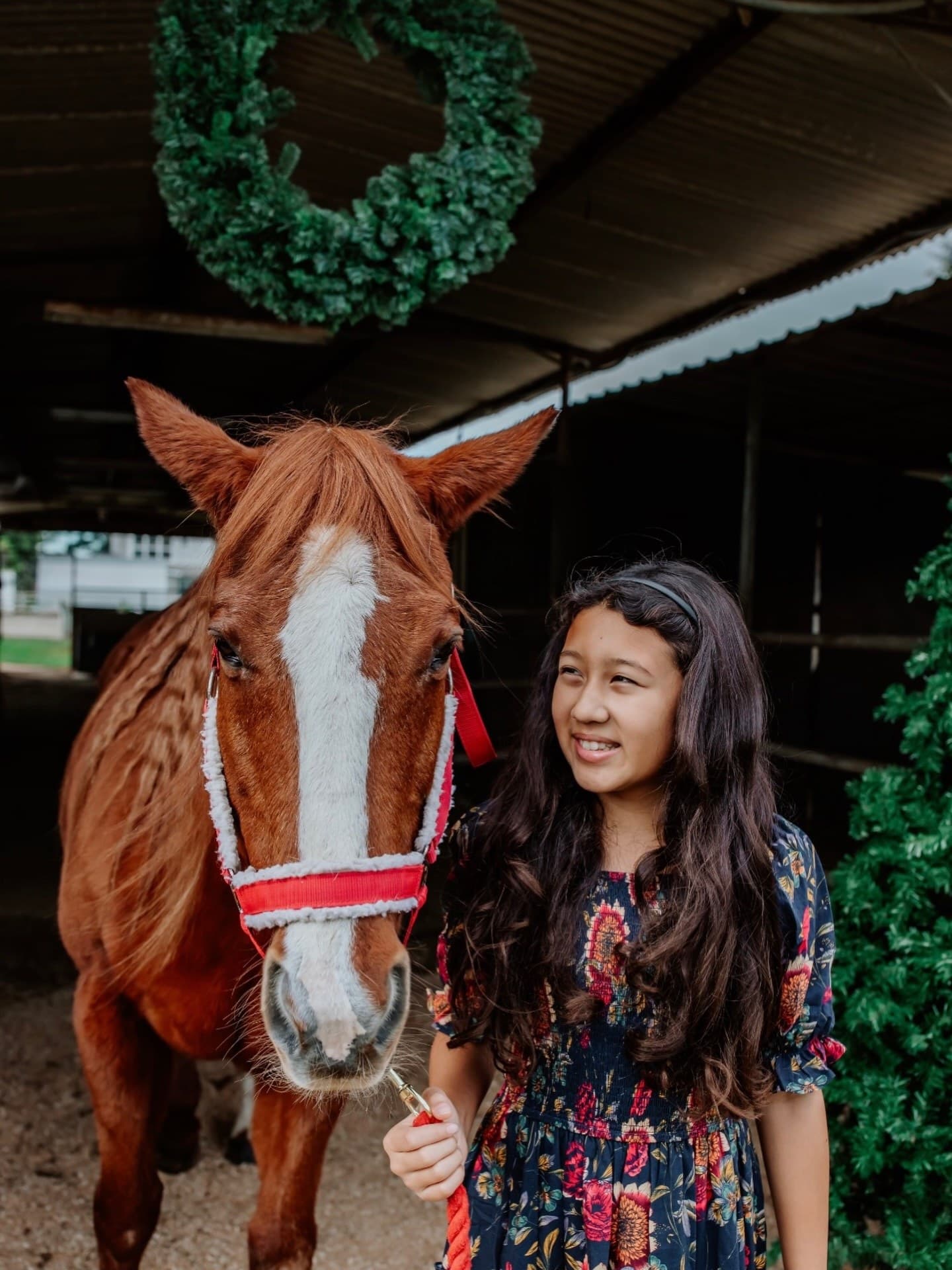 Kylie Akimoto photographed with a horse in a lifestyle portrait